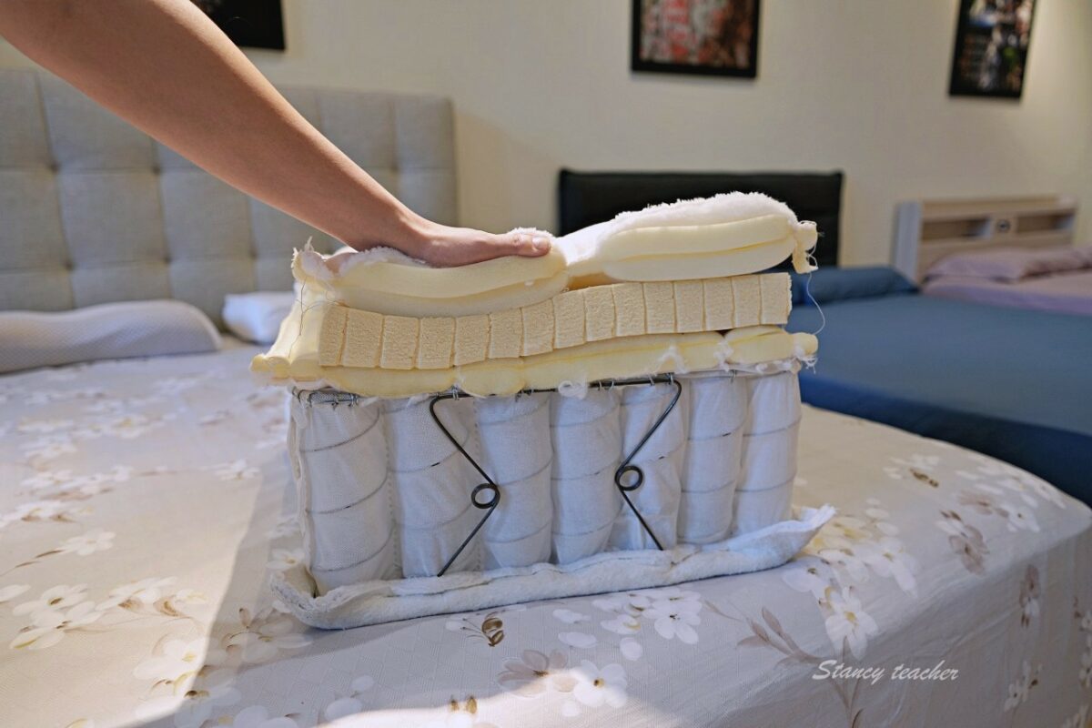 用手按壓床墊剖面樣品：乳膠層與袋裝獨立筒